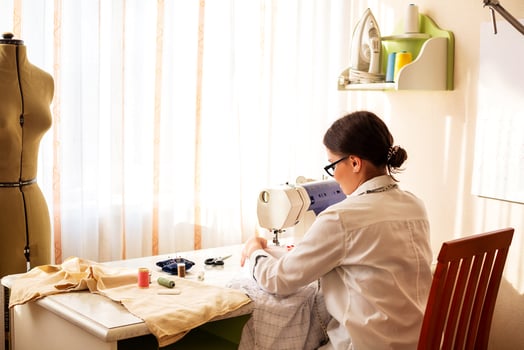Female dressmaker creating clothes in workshop photo