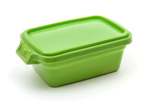 A green plastic lunch box isolated on a white background. photo