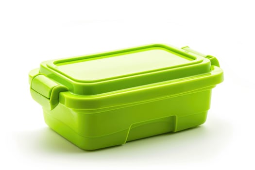 A green plastic lunch box isolated on a white background. photo