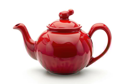 A red ceramic teapot isolated on a white background. photo