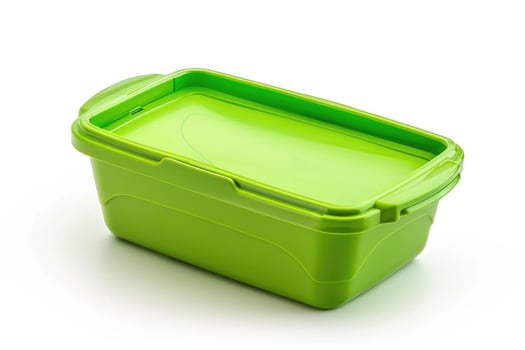 A green plastic lunch box isolated on a white background. photo