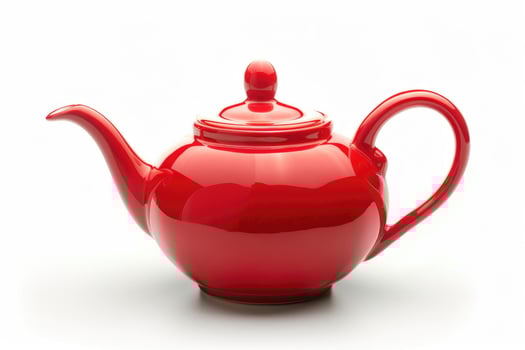 A red ceramic teapot isolated on a white background. photo