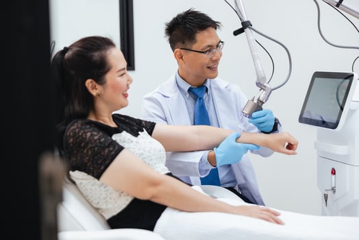 woman is getting a treatment from a doctor photo