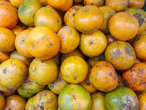 piles of orange fruit ready to eat or sell at the market photo