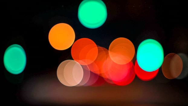 Blurred lights evening city traffic bokeh. Defocused night city traffic. Blurred lights bokeh car headlights driving evening city road. City night traffic background photo