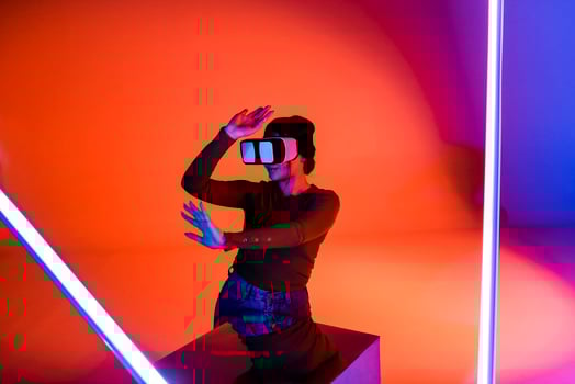 Cheerful woman in VR glasses under neon light photo