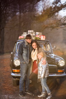 Stylish couple with daughter in park photo