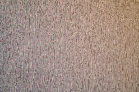 Acrylic light beige decorative fine-grained plaster texture. photo