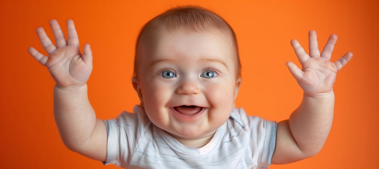 Adorable Baby Smiling With Raised Hands, Orange Background, Joyful Infant Expression, High-Resolution Photography, Happy Child Celebration, Perfect For Holiday Cards And Children's Advertisements photo
