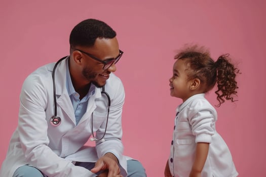 Pediatric Doctor with Smiling Child on Pink Background photo