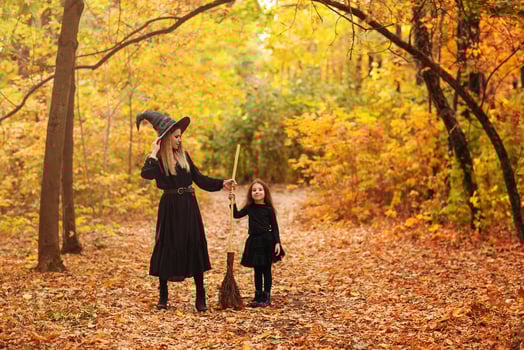 Mother and daughter sweeping path on Halloween day photo