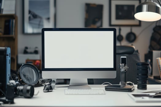 Computer Mockup Background on a white desk with various graphy gear surrounding it Background photo