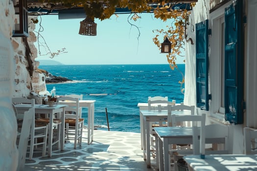 Charming white washed taverna by the beach with a stunning  of the azure sea background photo