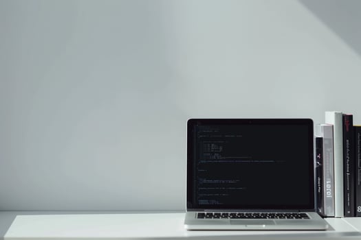 Laptop Mockup with Coding Books for Professional Setup Background photo