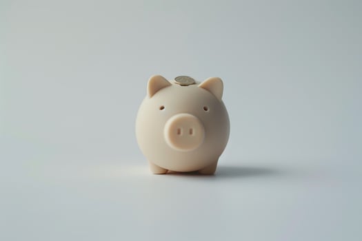 Single Coin Placed in a Piggy Bank Slot Background photo