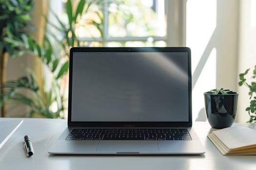 Laptop Mockup with Open Notebook on White Desk for   Work and Writing Setup photo