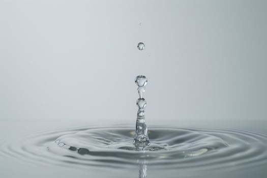 Single Water Droplet Impacting a Pool of Water with Dynamic Ripple Effects photo