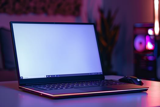 Laptop Mockup on a White Desk with Gaming Mouse and Accessories for a Streamlined Setup photo