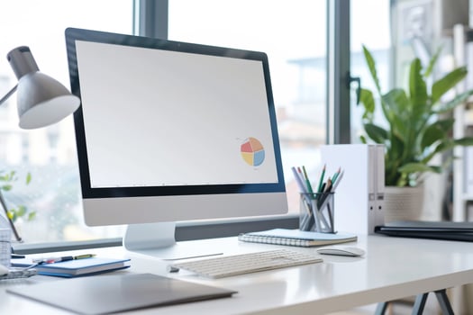 Digital Computer Mockup on White Desk with Marketing Brochures and Materials photo