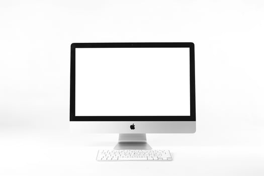 Computer Monitor Mockup with White Screen on Glossy Surface photo