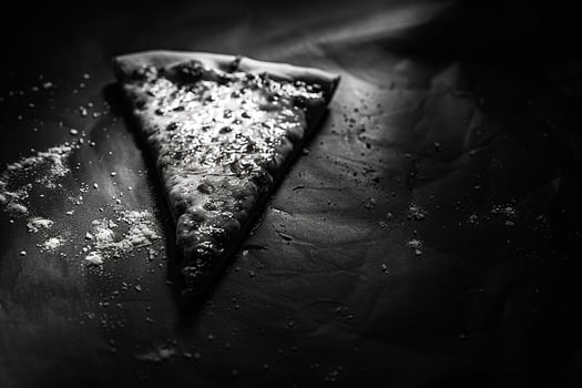 White Cheese Pizza Slice with Artistic Lighting and Dark Background photo