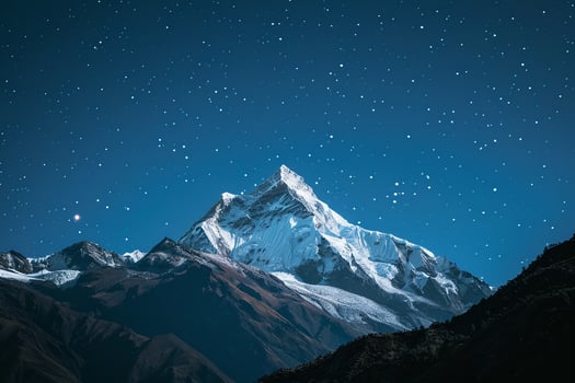 Snow Capped Mountain Peak Under a Starry Night Sky with a Majestic Scenic photo