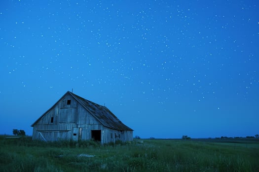 Barn in Green Meadow with Starry Night Sky photo