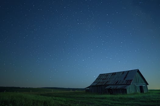 Barn with Starry Night Sky Over Meadow photo