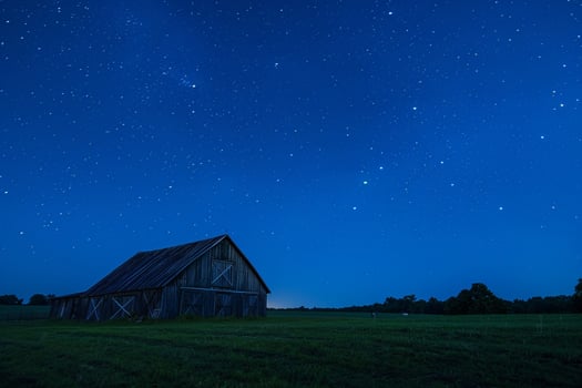 Barn Under Starry Night Sky in Meadow photo