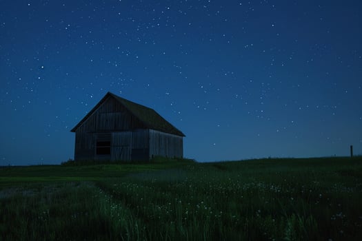 Barn in Green Meadow Under Starry Night photo