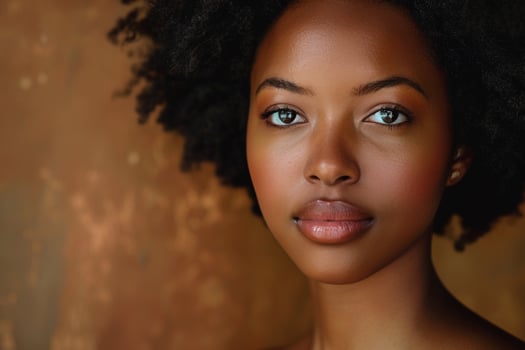 African Woman with Natural Hair Against Warm Earthy Brown Background photo