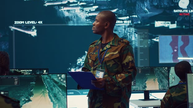 Navy captain oversees collecting important data for a national defense mission, targeting enemy vessels with the satellite radar system. Reconnaissance in a military base of operations. Camera A. photo