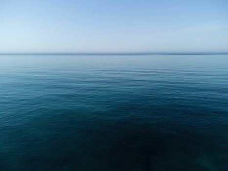 Aerial panoramic view of seascape with crystal clear azure sea and rocky shores. Yachts in a beautiful lagoon on backdrop of rocks. The concept of an ideal destination for summer travel and vacation. photo