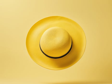 yellow beach hat isolated on yellow background. photo