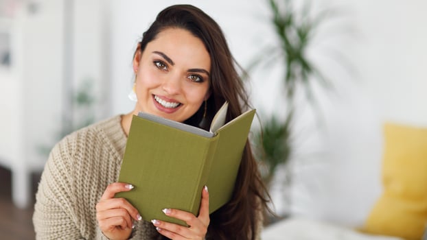Young happy brunette woman with book photo