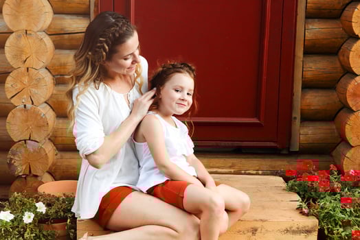 Happy mother and daughter embracing near door photo