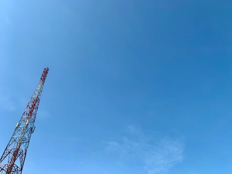 a large tower with a red and white antenna photo
