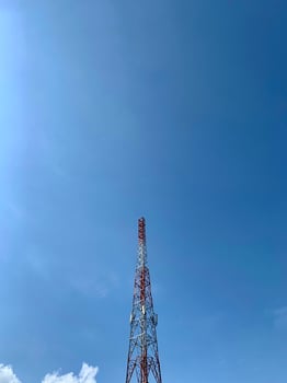 a large tower with a red and white antenna photo