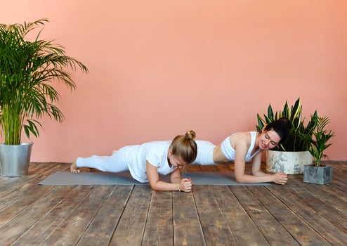 Smiling mother and daughter practicing yoga together photo