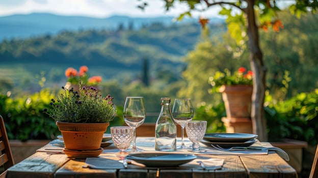 An elegantly set outdoor dining table with white plates, offering a breathtaking view of a picturesque vineyard landscape photo