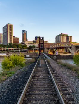 Early morning cityscape of St Paul and Twin Cities in Minnesota looking down rails of railroad bridge photo