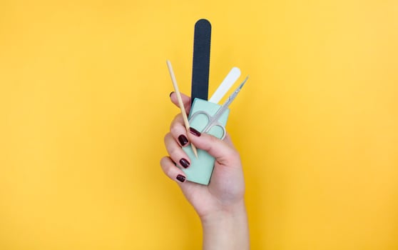 Crop woman with manicure supplies photo