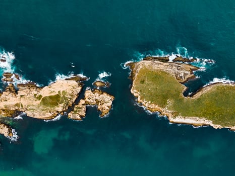 Aerial view of island Baleal naer Peniche on the shore of the ocean in west coast of Portugal. Baleal Portugal with incredible beach and surfers photo