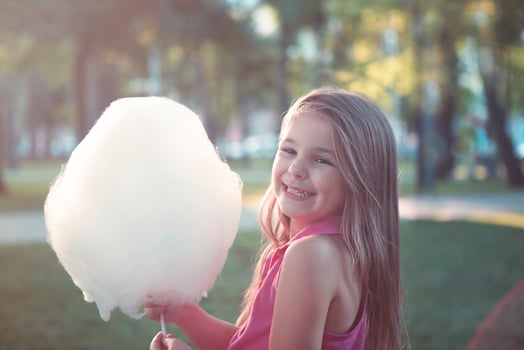 Portrait of small girl with sweet cotton candy photo