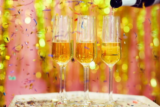 Crop woman pouring champagne during Christmas celebration photo