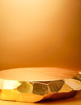 Golden Rock Platform on Orange Background photo