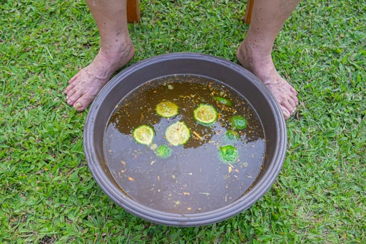 Close-up of the foot spa with herbs water for relaxation treatment. photo