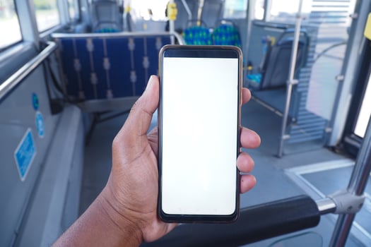 young man hand using smart phone with green screen inside of metro train photo