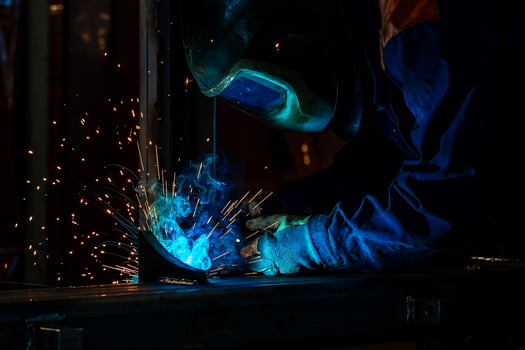 welder and welding sparks, construction and metal work industrial concept, metal welding with sparks photo