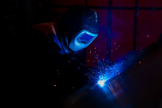 welder and welding sparks, construction and metal work industrial concept, metal welding with sparks photo